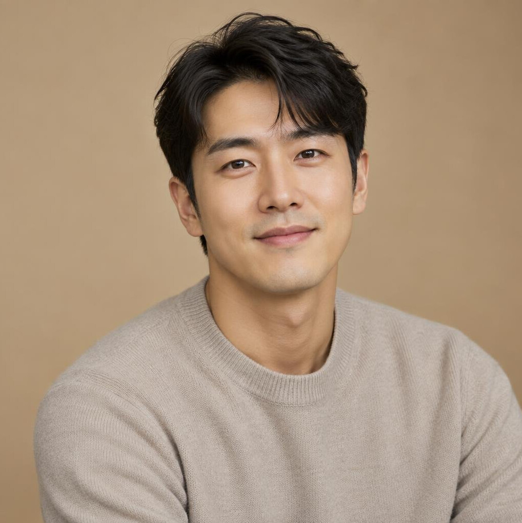 Studio portrait of a young East Asian man in a sweater