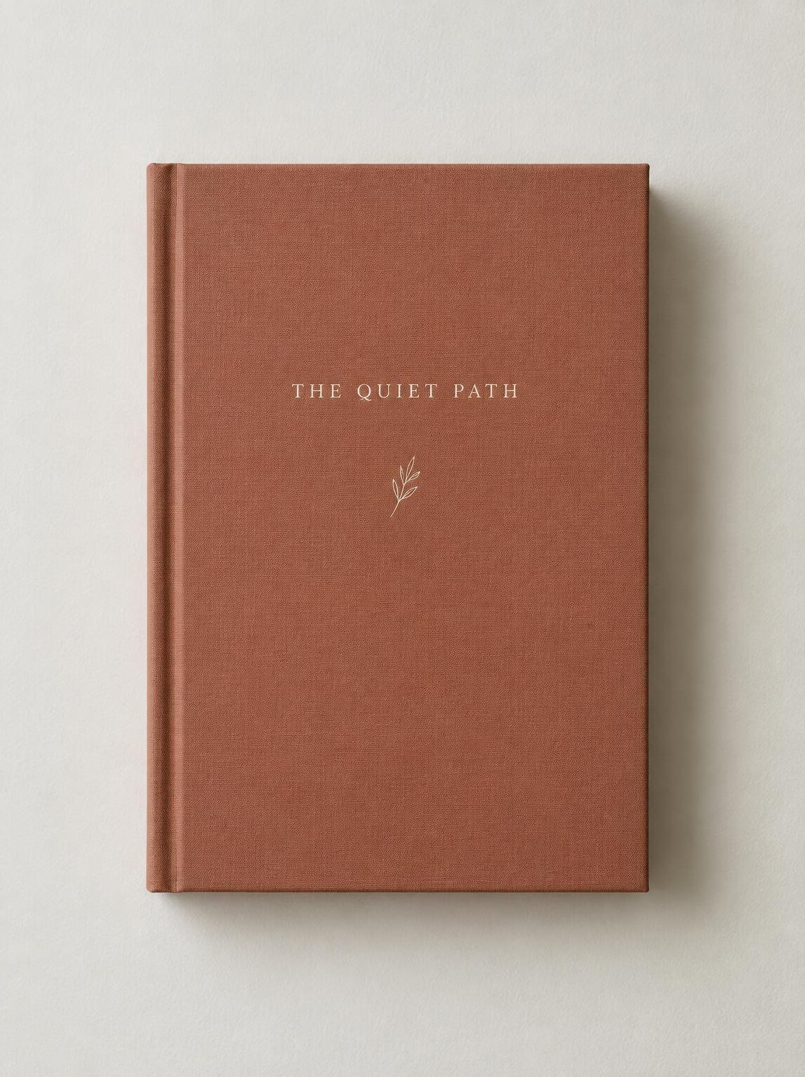 Book with a plain cover held against a light wall